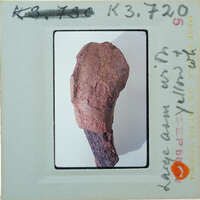 Fragment of terracotta arm on white background.