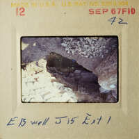 A photograph of an excavation site with handwritten notes.