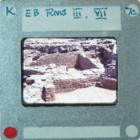 Excavated stone walls in various directions forming rooms.