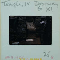 Marble step and doorway in muddy floor of building interior.