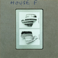 Two sets of partially reassembled pottery showing horizontal wavy lines.