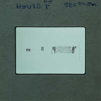 A close-up image of a film strip with handwritten notes and printed text on it.