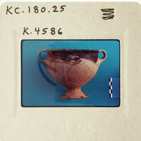A photograph of an ancient Greek vase with a blue background.