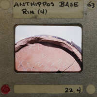 Old clay pot with writing on its side.