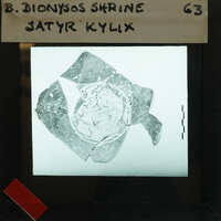 Partially reassembled kylix bowl nfrom above with satyr.