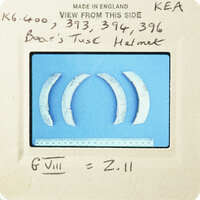 Old metal teeth with worn edges and a handwritten note on paper.