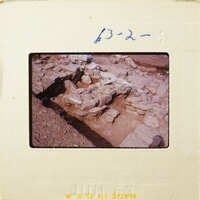 Ancient ruins with stone walls and foundations, partially excavated.