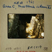 A photograph of an area with a brick structure, possibly ruins, taken from a low angle looking up towards a light source.