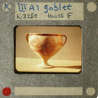 Ancient Greek vase with intricate designs on display.