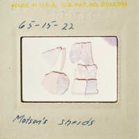 A collection of Monton's shards on a white background, with a label and handwritten notes.