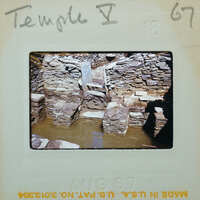 Stone ruins of a historical building with water around it.