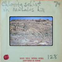 Rocky landscape with mountains and hills, labeled "Chlorite Schist in Michalos Hill".