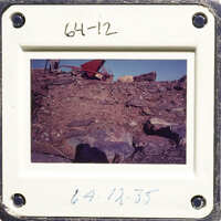 Rocky terrain with scattered debris and a clear sky.