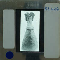 An old photo of a statue on film strip.