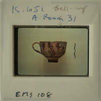 Antique cup with floral design on white background.