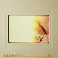 A faded photograph of a rocky landscape with a yellowish tint.