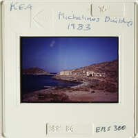 A sepia-toned photograph showing an ancient coastal settlement with ruins and water.