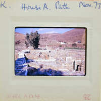 The image shows a photograph of an ancient archaeological site with ruins and columns.