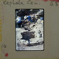 Two people working on excavating ancient ruins.