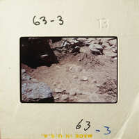 Old photograph showing excavated archaeological site with exposed layers and artifacts.