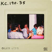 A group of people dancing and enjoying themselves at a party, with an old photo style border. Catalog number KC.190.35