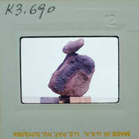 A photograph of a rock specimen on a stand.