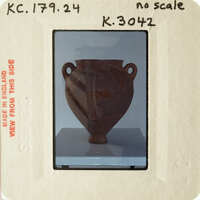 Ancient clay pot displayed on a pedestal.