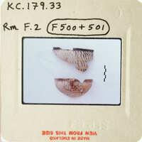 Two ancient pottery shards with visible cracks and texture, displayed on a white surface.