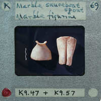 Marble spout on left and legs from figurines on right.