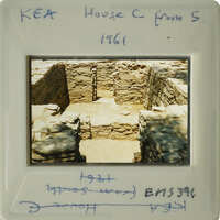 Old photograph of an archaeological site with stone ruins, possibly from a historical building or structure.