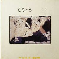 Ancient ruins with exposed stone and dirt, possibly an archaeological site.