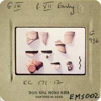 These are small, ancient pottery shards on display.