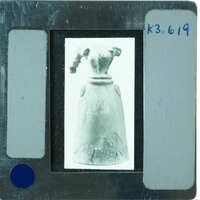 Headless restored terracotta figuring from front.