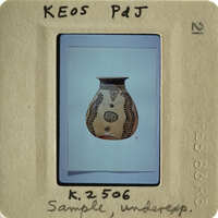 Ancient Greek vase with intricate designs, photographed and displayed on a card.