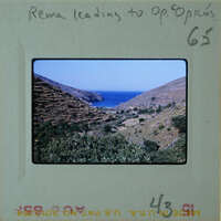 A vintage photo of a coastal landscape with mountains and water, labeled "REMA LEADING TO OPOCIOS".