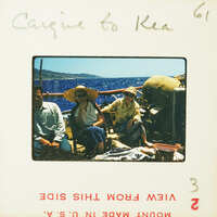 Three people sitting on a boat with blue ocean and land in the background.