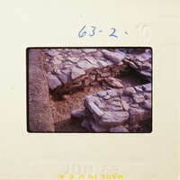 Old photograph of stone ruins with visible film strip and date stamp.