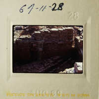 A photograph of an ancient stone structure, possibly ruins, with a handwritten note indicating the date and location.