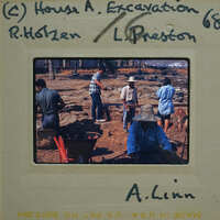 A vintage photograph of people working on a farm with handwritten notes and numbers on the back.