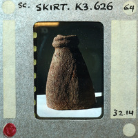 Partially reassembled terracotta figurine fragment of skirt K3.626.
