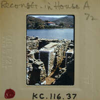 An old photograph of a stone structure near water, possibly ruins or an ancient building.