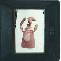 Partially restored figurine on white background.