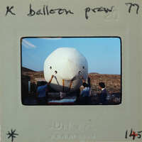 A group of people working on an unusual large balloon.