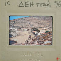 Old photograph of a village with dirt roads and stone houses, taken on August 7, 1976.