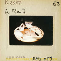 A photograph of an ancient Greek vase with intricate designs on display.