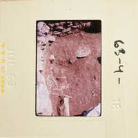 A photograph with an image of a rocky area and dirt, possibly from an archaeological site.