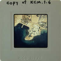 Picture of a small island with buildings and water, taken from an aerial perspective.