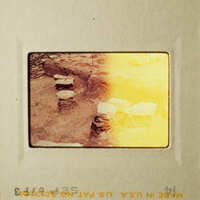 The photo shows an ancient archaeological site with stone ruins and a yellowish tint.