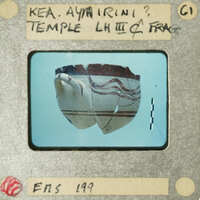 Ancient clay pottery with visible cracks and lines, photographed on a light background.