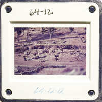 The photo shows an ancient archaeological site with ruins and vegetation.